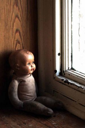 An Asylum Doll in The Window