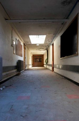 An Asylum Corridor with Blue Flooring