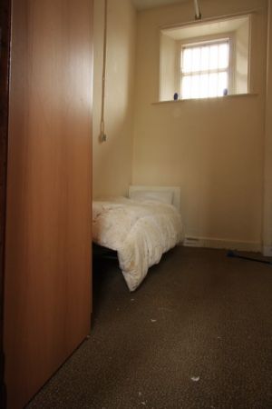 A made up bed in a Cell